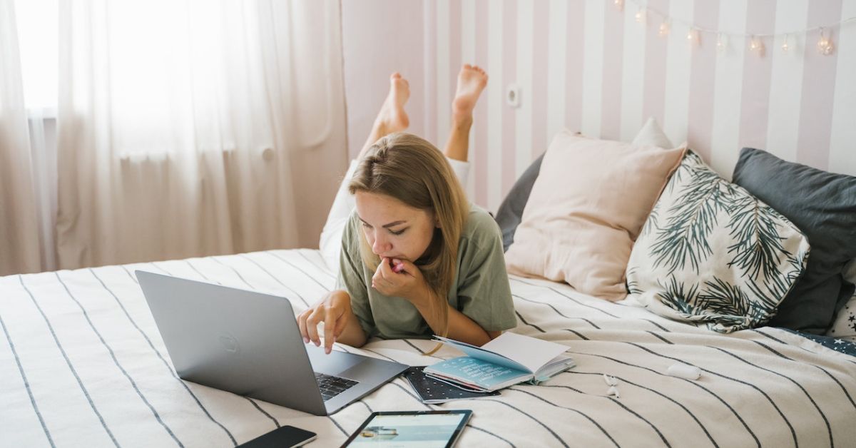 woman working remotely from her bed - 247 Self Storage office space in storage facilities