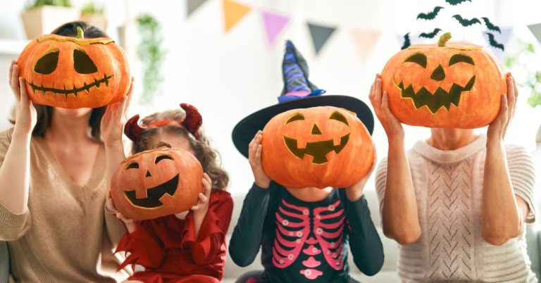 four people with Halloween pumpkins on their faces - 247 Self Storage self storage