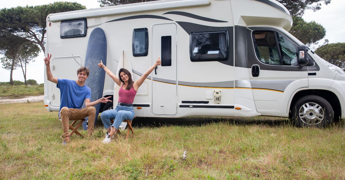 couple by their rv with a surfboard - 247 Self Storage rv storage