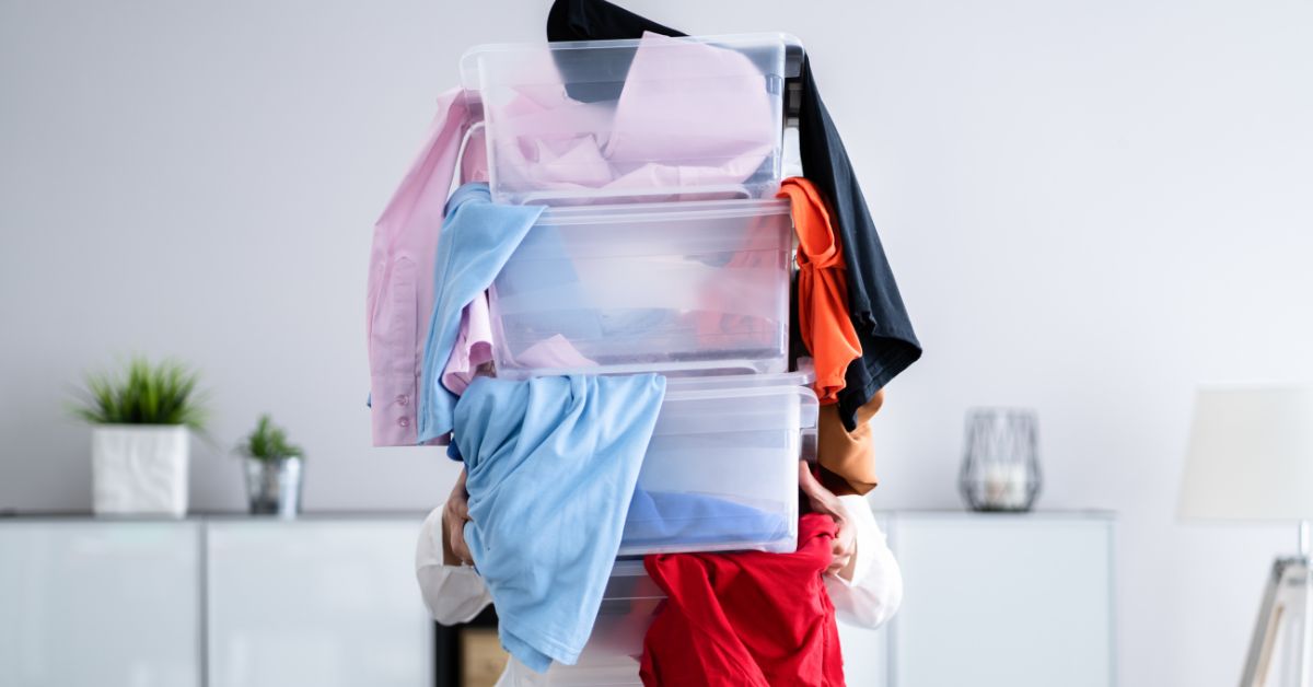 person holding three clear storage bins - 247 Self Storage self storage