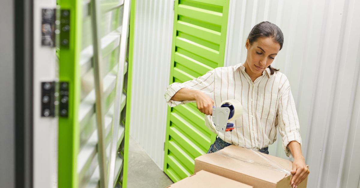 woman taping boxes in a storage facility - 247 Self Storage self storage