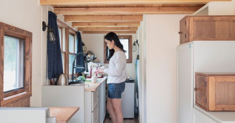 woman in kitchen of her tiny home - 247 Self Storage Self Storage