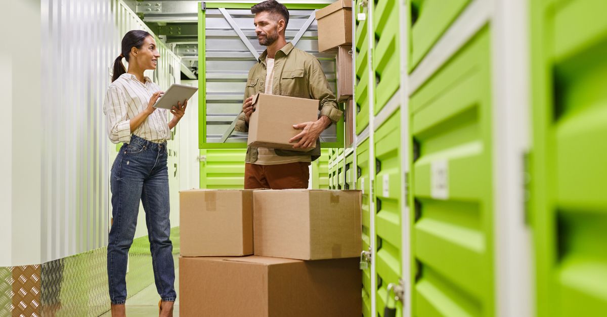 man and woman packing boxes into a self storage unit - 247 Self Storage Self Storage