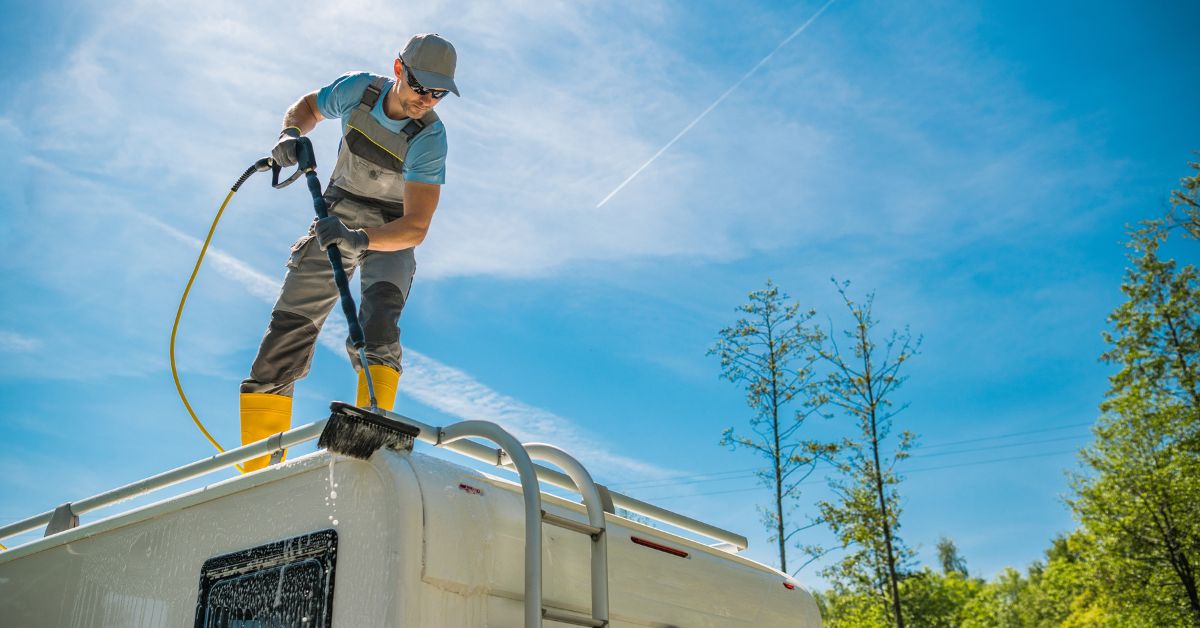 man spraying top of rv with water - 247 Self Storage rv storage solutions